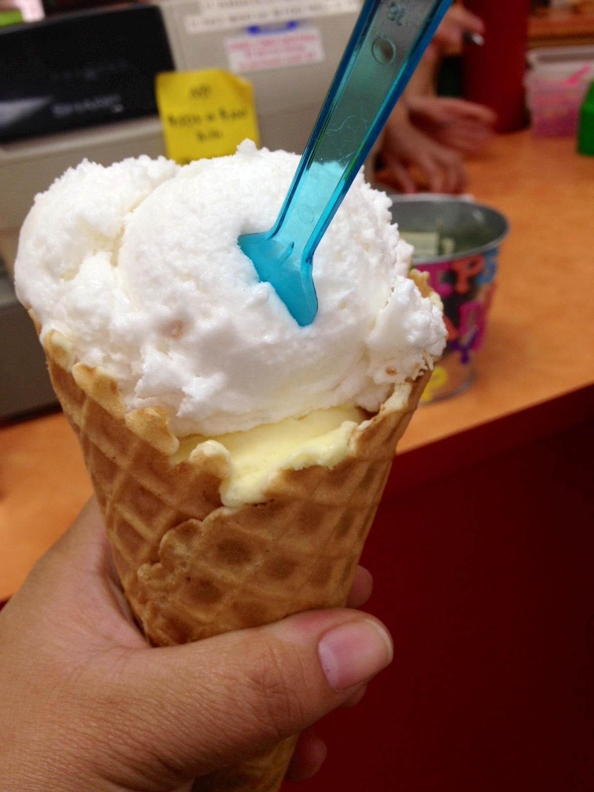 coconut and mango sorbets in a waffle cone
